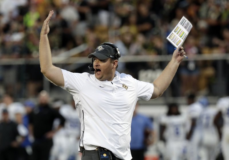 FILE - In this Dec. 1, 2018, file photo, Central Florida head coach Josh Heupel waves his arms during the first half of the American Athletic Conference championship NCAA college football game against Memphis, in Orlando, Fla. Heupel, Notre Dame&#x2019;s Brian Kelly and Alabama&#x2019;s Nick Saban are the finalists for The Associated Press national college football coach of the year after leading their teams to unbeaten regular seasons. The winner will be announced Monday, Dec. 17. (AP Photo/John Raoux, File)