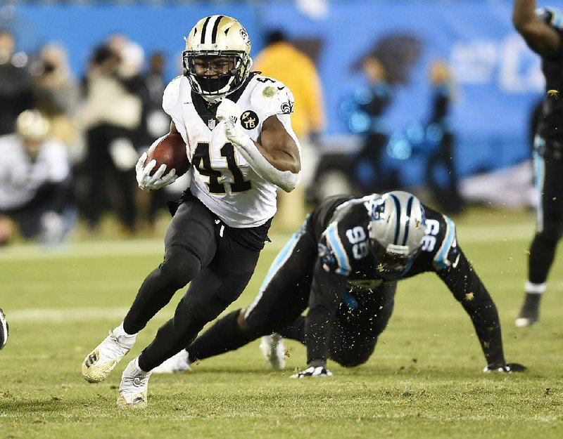 Alvin Kamara (left) finished with 103 yards from scrimmage and a touchdown to lead the New Orleans Saints to a victory over the Carolina Panthers on Monday night in Charlotte, N.C. The Saints (12-2) took a one-game lead in the NFC over the Los Angeles Rams. The Panthers (6-8) have lost six consecutive games after a 6-2 start.