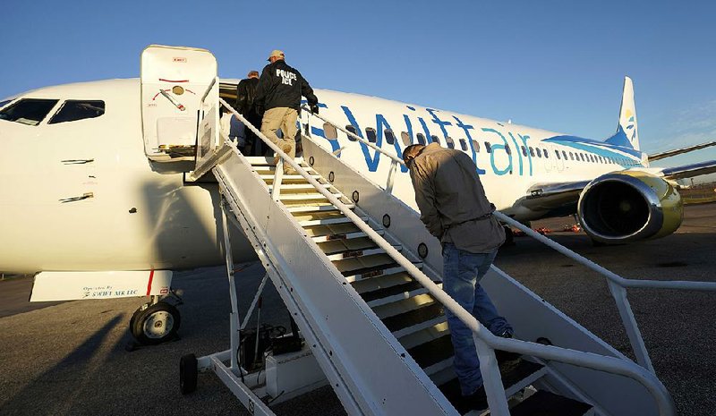Migrants who entered the United States illegally are deported on a flight to El Salvador by U.S. Immigration and Customs Enforcement in Houston last month.