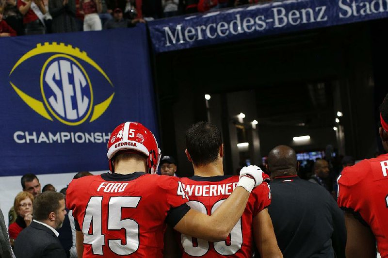 Georgia tight ends Luke Ford (left) and Charlie Woerner head to the locker room after losing to Alabama in the SEC Championship Game on Dec. 1 in Atlanta. The Bulldogs will play in the Sugar Bowl on Jan. 1 against Texas in New Orleans.