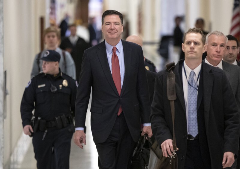 Former FBI Director James Comey, with his attorney, David Kelley, far right, arrives on Capitol Hill in Washington, Monday, Dec. 17, 2018, to testify under subpoena in a second closed-door interview with the GOP-led House Judiciary and Oversight Committees in their probe of conduct by federal law enforcement officials in the investigation of President Donald Trump's alleged Russia ties, and Hillary Clinton's emails. (AP Photo/J. Scott Applewhite)