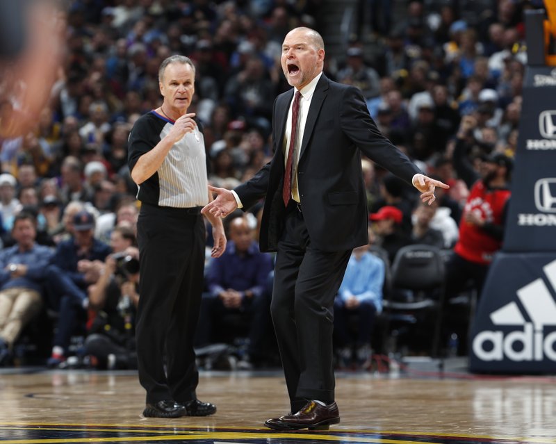 Denver Nuggets head coach Michael Malone, right, argues for a foul call as referee Mike Callahan looks on in the second half of an NBA basketball game against the Toronto Raptors Sunday, Dec. 16, 2018, in Denver. The Nuggets won 95-86. (AP Photo/David Zalubowski)