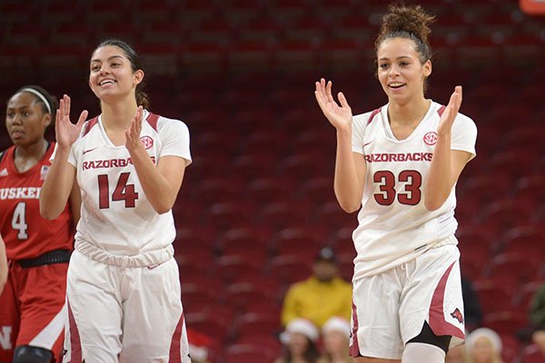 Arkansas guards Chelsea Dungee (33) and Jailyn Mason (14) celebrate during the closing moments against Nebraska Tuesday, Dec. 18, 2018, during the second half of the Razorbacks' 84-80 win in Bud Walton Arena. 