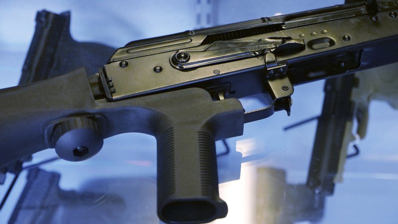  In this October 2017 file photo, a little-known device called a "bump stock" is attached to a semi-automatic rifle at the Gun Vault store and shooting range in South Jordan, Utah. The Trump administration is moving to officially ban bump stocks, which allow semi-automatic weapons to fire rapidly like automatic firearms. A senior Justice Department official said Tuesday bump stocks will be banned under the federal law that prohibits machine guns. It will take effect in late March. (AP Photo/Rick Bowmer)

