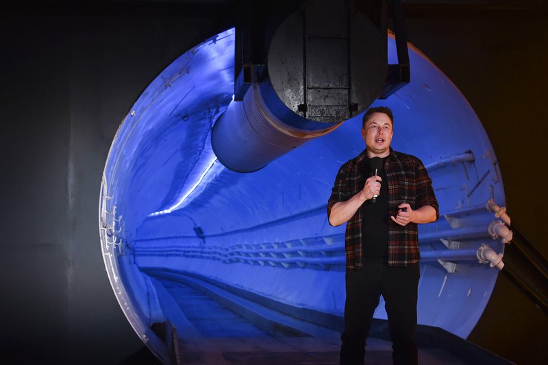 Elon Musk, co-founder and chief executive officer of Tesla Inc., speaks during an unveiling event for the Boring Co. Hawthorne test tunnel in Hawthorne, Calif., on Tuesday, Dec. 18, 2018. Musk has unveiled his underground transportation tunnel, allowing invited guests to take some of the first rides ever on the tech entrepreneur's solution to "soul-destroying traffic." (Robyn Beck/Pool Photo via AP)