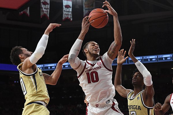 Arkansas forward Daniel Gafford (10) fights for a rebound against Georgia Tech's Jose Alvarado (left) and Khalid Moore during a game Wednesday, Dec. 19, 2018, in Fayetteville. 