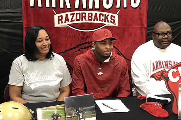 Rison defensive back Malik Chavis (center) sits with his mother, Pamela, and father, Johnny, during a ceremony Wednesday, Dec. 19, 2018, in Rison. 