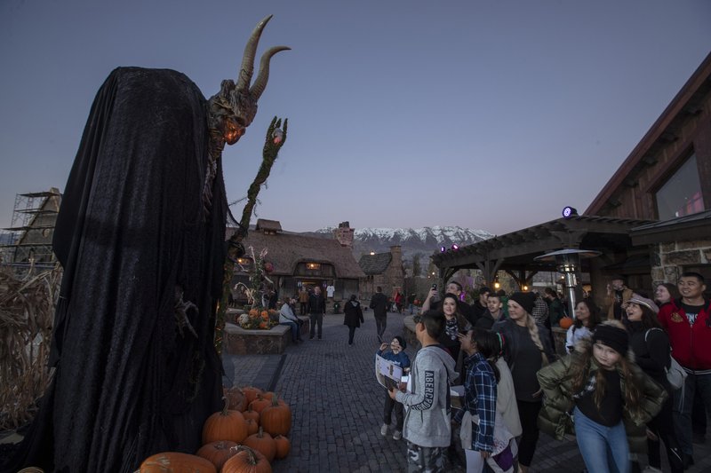 Visitors pay a visit to the giant Fae King at Evermore park in Pleasant Grove, Utah. The park, open seasonally, offers guests an immersive fantasy experience.