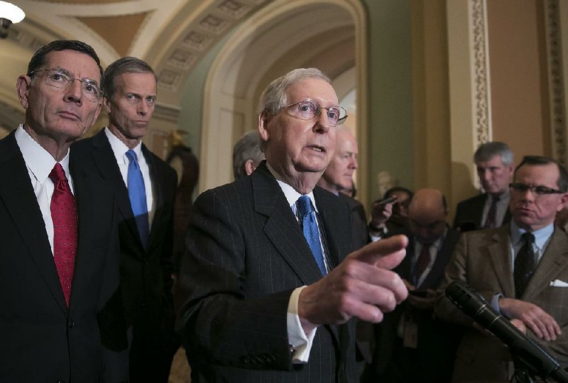 Senate Majority Leader Mitch McConnell, R-Ky., joined from left by Sen. John Barrasso, R-Wyo., and Sen. John Thune, R-S.D., speak following their weekly strategy session, at the Capitol in Washington, Tuesday, Dec. 11, 2018. 