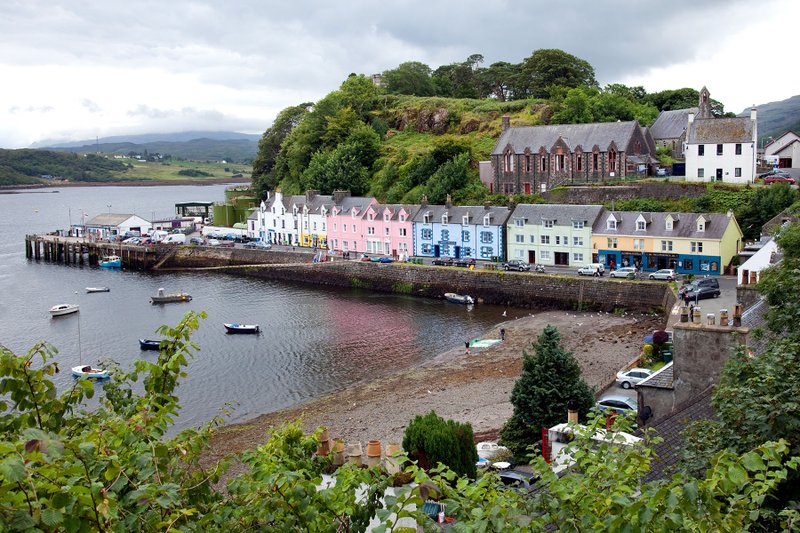 Portree, the largest town on the Isle of Skye, is nestled deep in its protective harbor, where colorful houses look out over bobbing boats and the surrounding peninsulas.