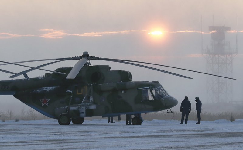 A search and rescue helicopter are seen before a flight to the landing area of the Soyuz MS-09 capsule with the International Space Station (ISS) crew onboard during sunrise in the town of Zhezkazgan, formerly known as Dzhezkazgan, Kazakhstan, Thursday, Dec. 20, 2018. (Shamil Zhumatov/Pool Photo via AP)