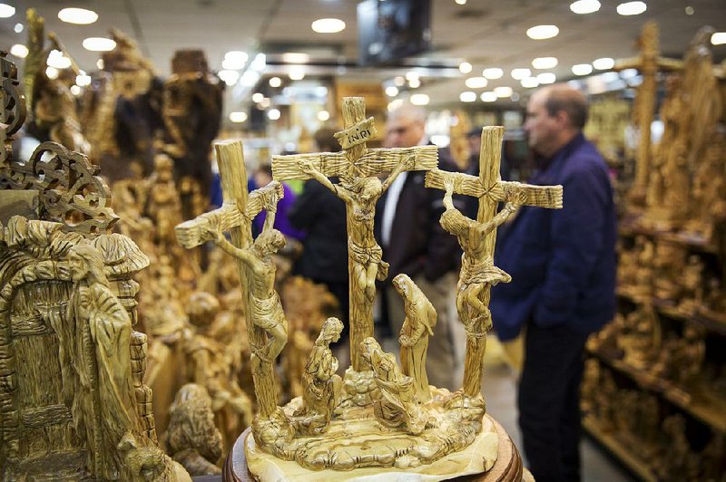 People visit a shop near the Church of the Nativity, built atop the site where Christians believe Jesus Christ was born, in the West Bank city of Bethlehem. 