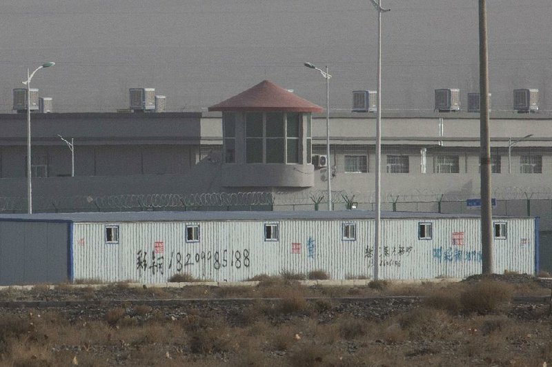 A facility in the Kunshan Industrial Park in western China’s Xinjiang region features a guard tower and barbed-wire fences. 
