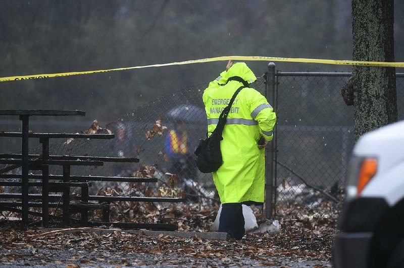 An investigator works at the scene of a small plane crash in a park in Atlanta on Dec. 20, 2018.