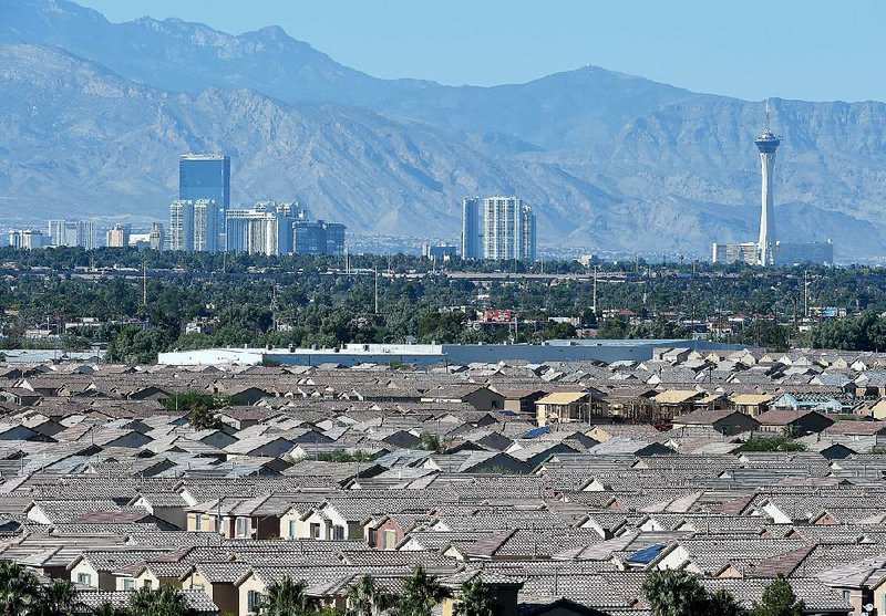 A view of the Las Vegas Strip, including the Stratosphere Hotel and Casino (right), is seen behind nearby homes in 2015 from Sam Boyd Stadium. 