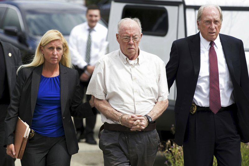 In this July 24, 2017 file photo, Rev. John Thomas Sweeney, center, walks into court to be arraigned in Leechburg, Pa. The Roman Catholic priest on Friday, Dec. 21, 2018, became the first person sentenced to prison as a result of a Pennsylvania grand jury investigation that found hundreds of clergy had abused children over seven decades. (Antonella Crescimbeni/Pittsburgh Post-Gazette via AP, File)