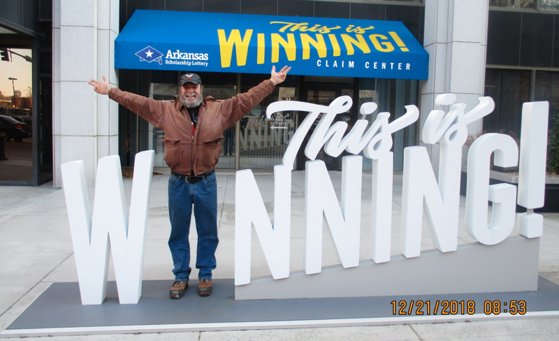 David Stratil of West Milwaukee, Wis., is shown posing outside of Arkansas Scholarship Lottery headquarters in this photo released by the lottery.