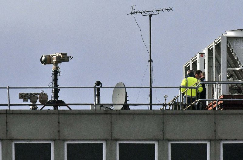 Security personnel deploy counter-drone devices Friday on a rooftop at Gatwick Airport, part of what Assistant Chief Constable Steve Barry of the Sussex police said included “technical, sophisticated options to detect and mitigate drone incursions, all the way down to less sophisticated options.” 
