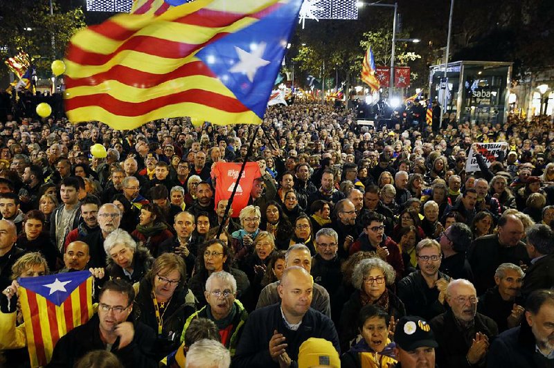 Protesters wave Catalan flags Friday in Barcelona, Spain.