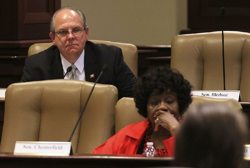 Sen. Terry Rice (left), R-Waldron, asks state Department of Human Services officials a question Friday during a meeting of the Arkansas Legislative Council about Medicaid-funded, non-emergency transportation services. 