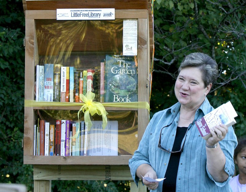 File photo/NWA Democrat-Gazette/DAVID GOTTSCHALK Jo Ann Wardein describes the Little Free Library at Gulley Park in Fayetteville on Oct. 7, 2013.