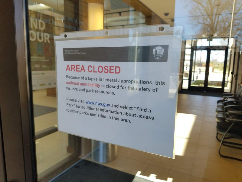 A sign on the door of the Central High School National Historic Site in Little Rock informs visitors it is closed during the government shutdown.