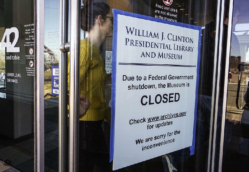 Visitors at the Clinton Presidential Center in Little Rock learn Saturday that the center’s museum is closed because of the partial federal shutdown, but the gift shop and restaurant in the center were open.