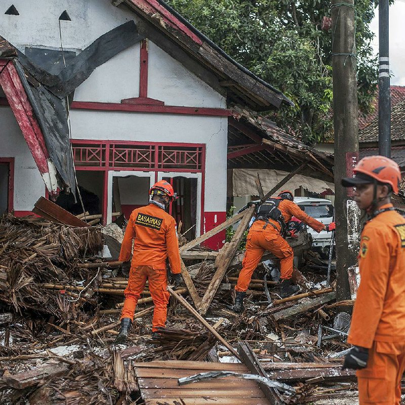 Rescuers search for tsunami victims Sunday in the Carita district of Indonesia’s Java island. Dozens of people were reported as missing on two islands after the tsunami struck Saturday night, the Disaster Management Agency said. 