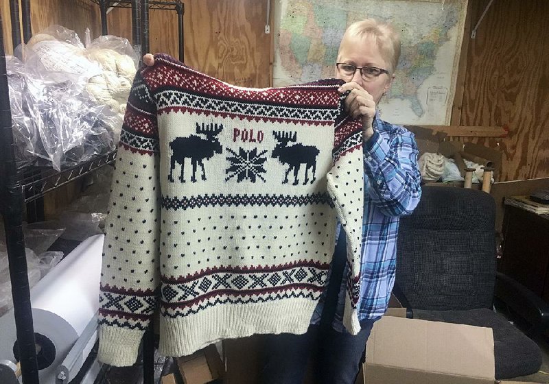 Debbie McDermott of East Jordan, Mich., shows the back of a Ralph Lauren sweater that was made using a yarn line made by her company, Stonehedge Fiber Mill. 