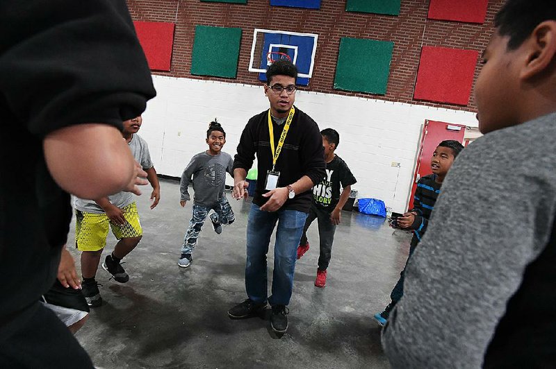 Alvin Hiram, 19, works with his stomp dance group Wednesday at Sonora Elementary School in Springdale. 