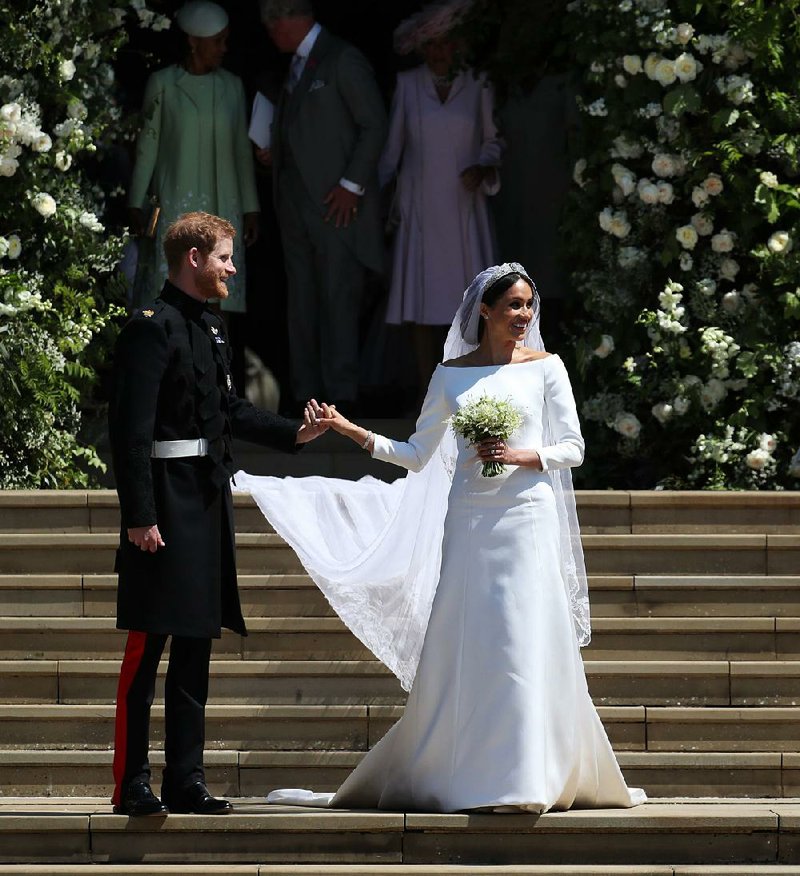 Meghan Markle and Britain’s Prince Harry stood on the steps of St George’s Chapel at Windsor Castle following their May wedding. 