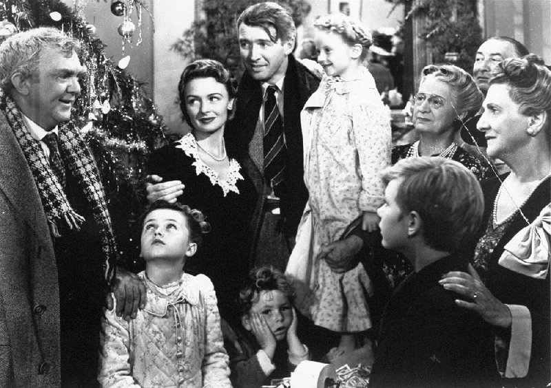 James Stewart (center) stars as George Bailey, who is reunited with his wife, played by Donna Reed (left center) and their children during the final scene of Frank Capra’s 1946 film, It’s a Wonderful Life.