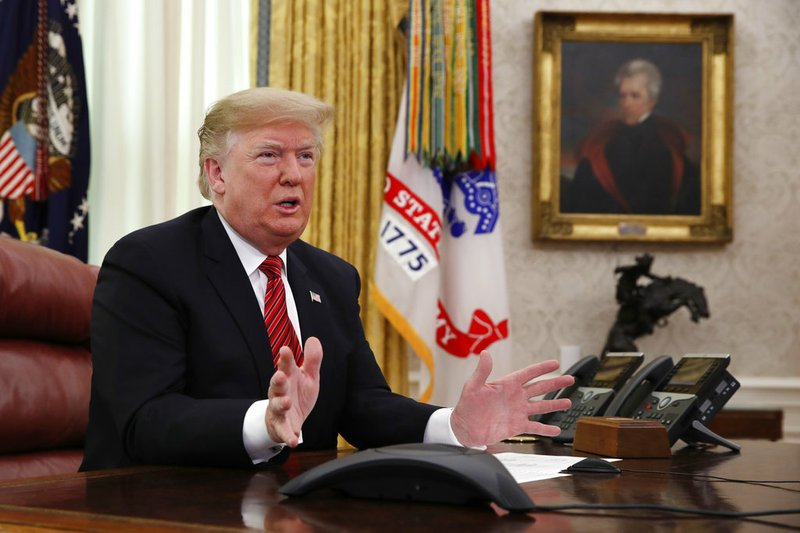 President Donald Trump greets members of the five branches of the military by video conference on Christmas Day, Tuesday, Dec. 25, 2018, in the Oval Office of the White House. The military members were stationed in Guam, Qatar, Alaska, and two groups in Bahrain. 