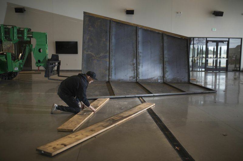 NWA Democrat-Gazette/CHARLIE KAIJO Artist Griffin Loop prepares to move Launch Intention, a sculpture he created for a park near Bentonville's airport.