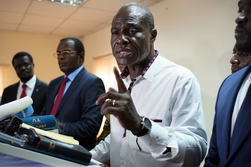 Congolese opposition presidential candidate Martin Fayulu and other opposition candidates address a news conference in Kinshasa, Congo, Tuesday Dec. 25, 2018. Fayulu asked that all cell phone operators who have provided the electoral commission with simcards for the voting machine disable them, as their use would about to an electronic vote, which is against the Congolese constitution. (AP Photo/Jerome Delay)