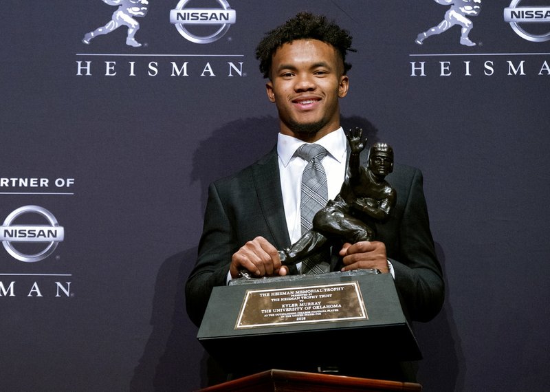 In this Dec. 8, 2018, file photo, Oklahoma quarterback Kyler Murray holds the Heisman Trophy after winning the award in New York.