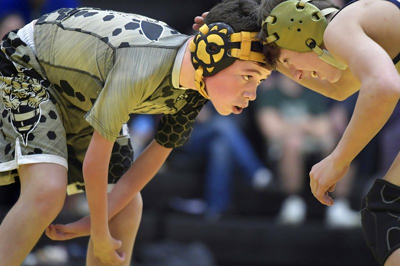 In this Tuesday, Dec. 18, 2018, photo Stevensville freshman wrestler Devin McLane, left, faces off Dillon's Noah Huffaker, as he competes in wrestling for Corvallis High School, despite a condition that makes him unable to use his arms during the Stevensville Mixer in Corvallis, Mont. McLane was born with Arthrogryposis Multiplex Congenita (AMC) and has limited use of his arms and hands. (Tommy Martino/The Missoulian via AP)