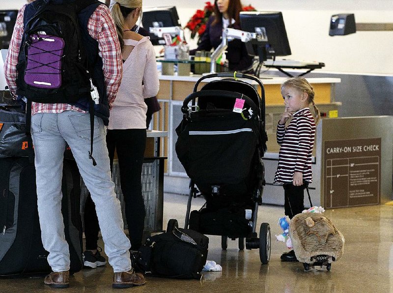 Arkansas Democrat-Gazette/THOMAS METTHE -- 12/26/2018 --
Harper Spohn, 4, of Columbus, Ohio, waits as her parents, Abram and Missy get checked in on Wednesday, Dec. 26, 2018, for their flight home at Bill and Hillary Clinton National Airport in Little Rock. 