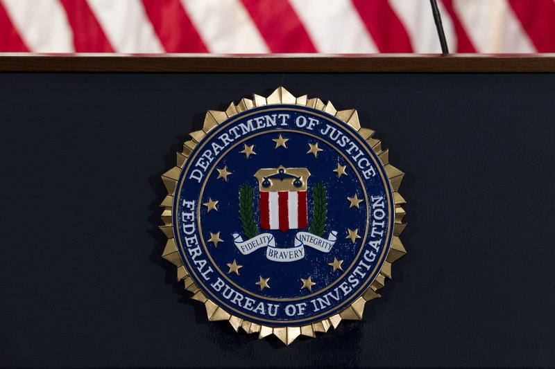 FILE - In this June 14, 2018, file photo, the FBI seal is seen before a news conference at FBI headquarters in Washington.  (AP Photo/Jose Luis Magana, File)