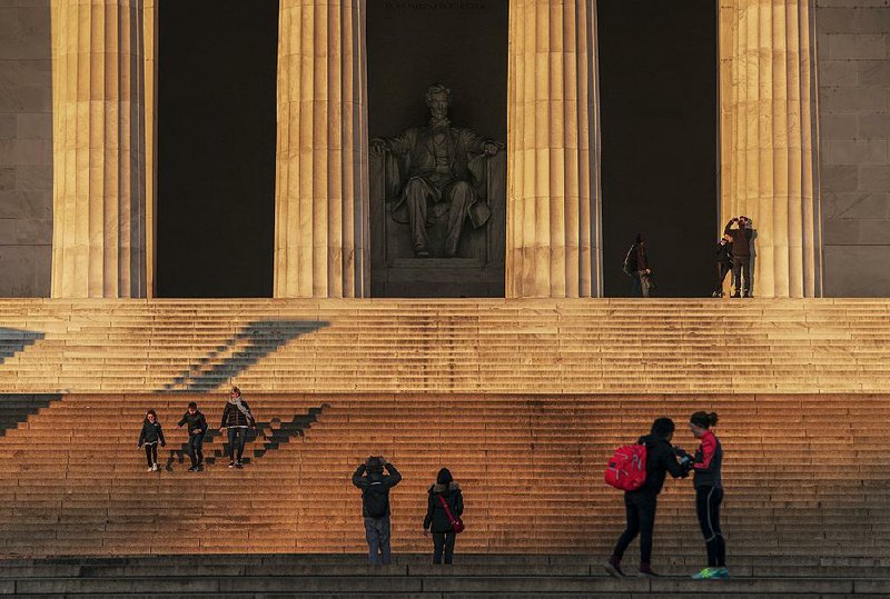 The Lincoln Memorial draws tourists Thursday in Washington, where national sites remain open but without visitor center services, much like most National Park Service facilities around the country. 