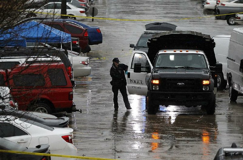 Little Rock police officers and crime scene investigators collect evidence Thursday after a woman and child were found dead at the Eagle Hill Apartments. 