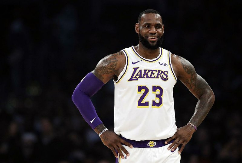 Los Angeles Lakers' LeBron James (23) smiles during a break in action during the first half of an NBA basketball game against the Memphis Grizzlies Sunday, Dec. 23, 2018, in Los Angeles. 