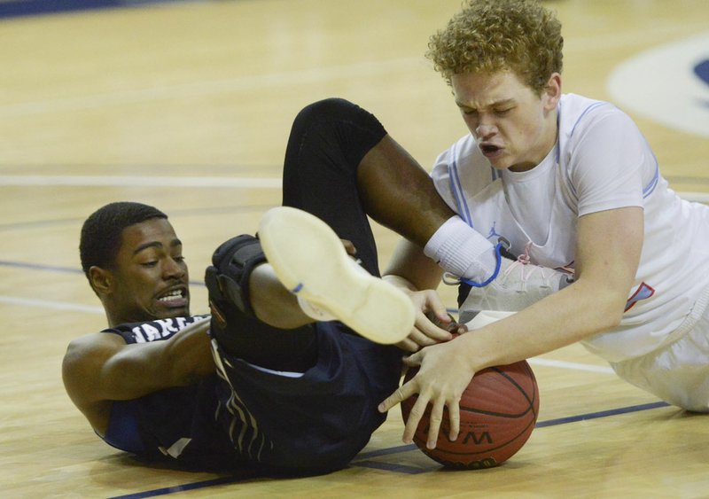 NWA Democrat-Gazette/CHARLIE KAIJO Fair guard Jacori Crandford (11) and Southside guard Elijah York (12) wrestle for possession of the ball Thursday during the Coca-Cola Christmas Classic basketball tournament at the Stubblefield Center in Fort Smith. Southside beat Fair, 48-47.