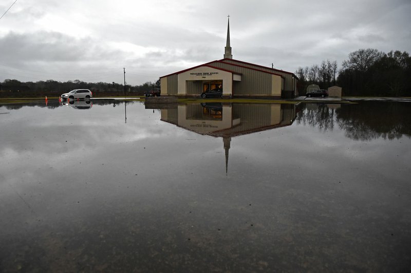 High water encroaches on the Treasures From Heaven Ministry on Mickens Road, Thursday, Dec. 27, 2018, as severe weather impacts the area in Baton Rouge, La. (Hilary Scheinuk/The Advocate via AP)