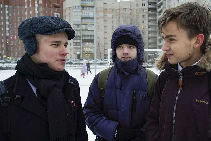 Leonid Shaidurov (from left) talks with Maxim Dautov and Andrei Vorsin outside their high school in St. Petersburg, Russia, last week. Shaidurov and Dautov are among Russia’s newest student activists, using social media to air a dispute with their principal. 