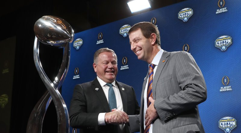 Notre Dame head coach Brian Kelly, left, and Clemson head coach Dabo Swinney share a laugh after the NCAA Cotton Bowl football coaches' news conference in Dallas, Friday, Dec. 28, 2018. Notre Dame is scheduled to play Clemson in the NCAA Cotton Bowl semi-final playoff Saturday. (AP Photo/LM Otero)