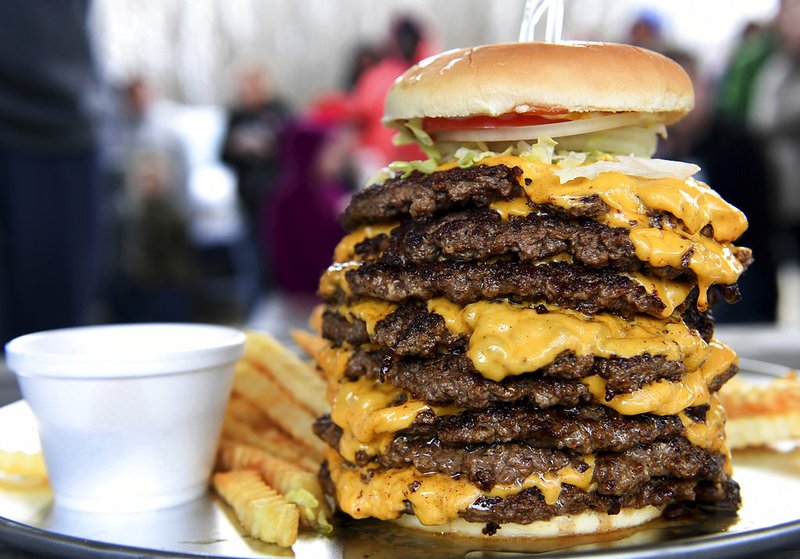 KC Finn's Big A** Burger is eight half-pound patties with 16 slices of cheeses. The challenge was conquered for the first time by YouTube star Randy Santel, Wednesday, Dec. 26, 2018. Santel finished the challenge, which included a 5lb burger, 1lb of fries and a drink, in 12:44. (Kenneth Cummings/The Jackson Sun via AP)