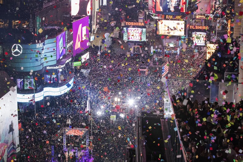 In this Jan. 1, 2017 file photo, revelers celebrate the new year as confetti flies over New York's Times Square. Year after year, people watching New York City's New Year's Eve celebration are told by city dignitaries and TV personalities that they are watching a million people gathered in Times Square. The AP asks experts whether it is actually possible to fit that many people into the viewing areas. (AP Photo/Mary Altaffer, File)

