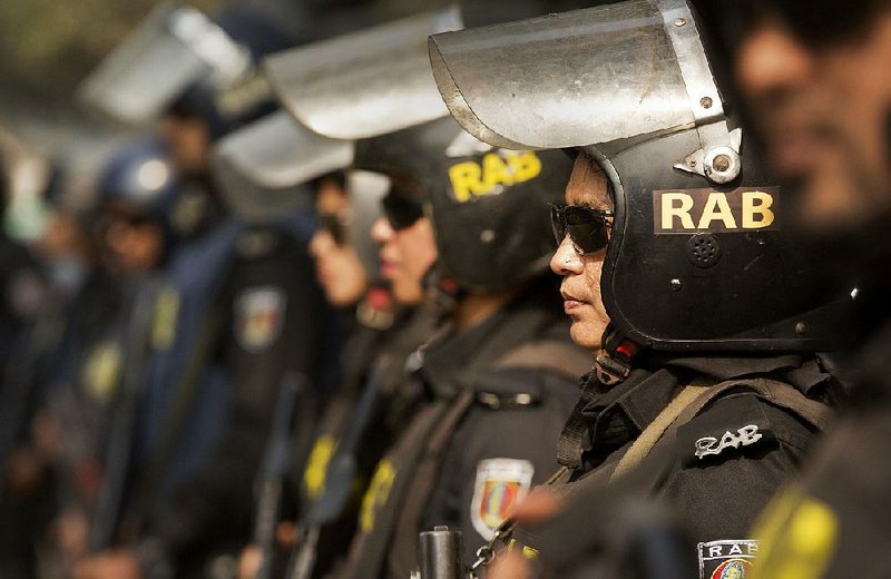 Female members of an elite Bangladesh rapid action battalion stand guard on a street in Dhaka on Saturday. 