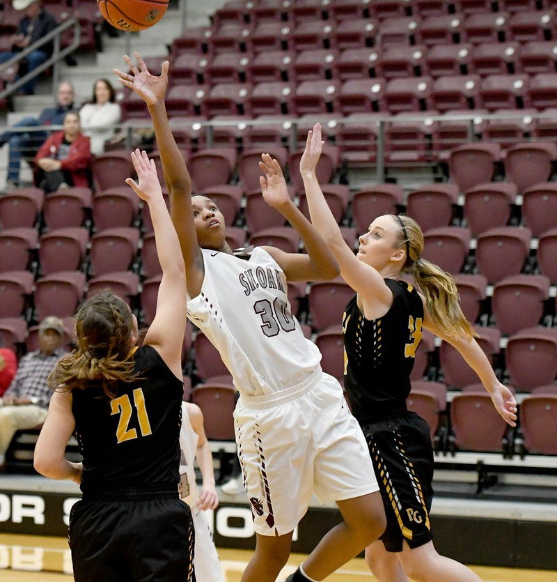 Bud Sullins/Special to Siloam Sunday Siloam Springs junior Jael Harried takes a shot while Prairie Grove defenders Kaylee Elder, left, and Emily Grant defending during Thursday's game in the Siloam Springs Holiday Classic. The Lady Panthers defeated the Lady Tigers 44-29.
